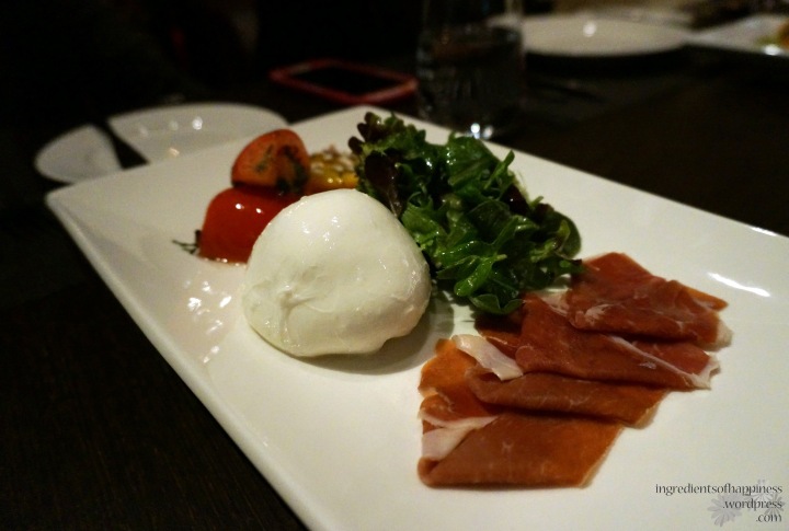 Delicious burrata cheese, roasted tomatoes, rocket and Parma ham